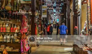 Shoppers buying spices, gold, perfumes, and souvenirs from Dubai traditional souks