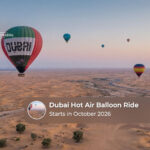 Hot air balloon rising over the Dubai desert during an early morning flight.