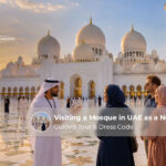 Non-Muslim visitors exploring a UAE mosque on a guided cultural tour while following the modest dress code